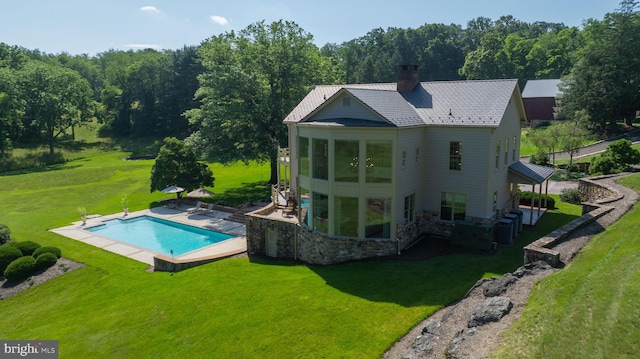 5751 Mount Pisgah Rd, York, PA 17406 - rear view of property featuring a lawn, a patio, a chimney, and an outdoor pool