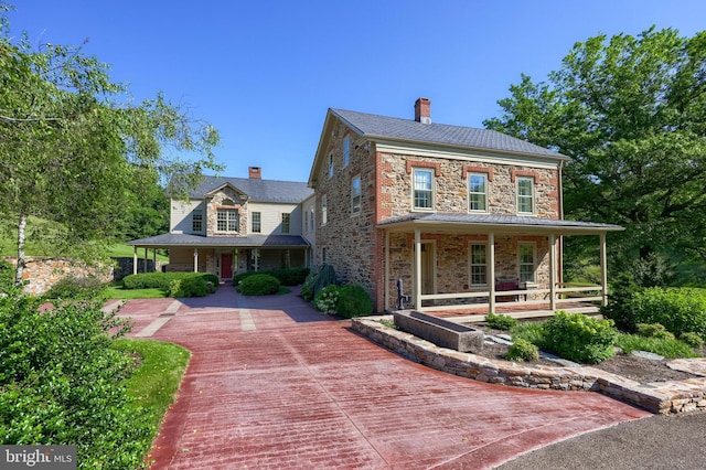 5751 Mount Pisgah Rd, York, PA 17406 - view of front of home with a porch, stone siding, and a chimney