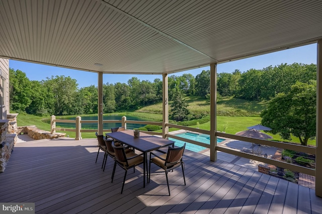 5751 Mount Pisgah Rd, York, PA 17406 - wooden deck featuring view of scattered trees, outdoor dining area, a hot tub, and an outdoor pool