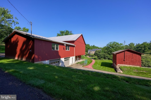 5751 Mount Pisgah Rd, York, PA 17406 - view of side of property with a lawn, a metal roof, and an attached garage