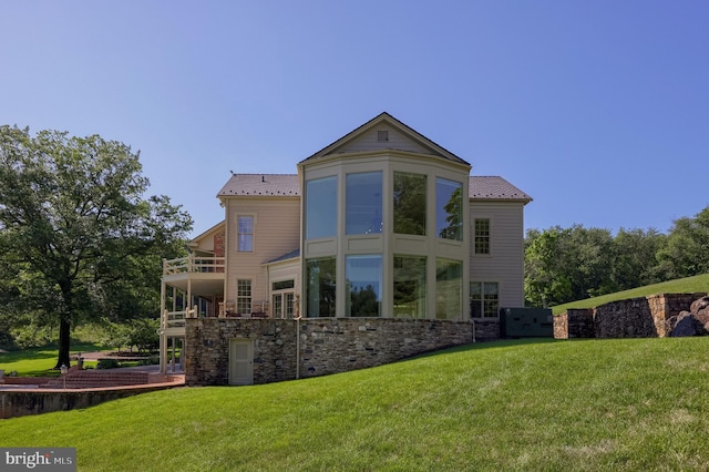 5751 Mount Pisgah Rd, York, PA 17406 - back of property featuring a balcony, stone siding, a lawn, and a metal roof