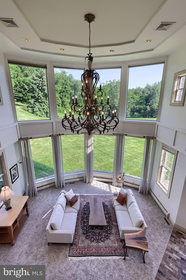 5751 Mount Pisgah Rd, York, PA 17406 - living area featuring a chandelier, brick patterned flooring, a baseboard heating unit, and a tray ceiling