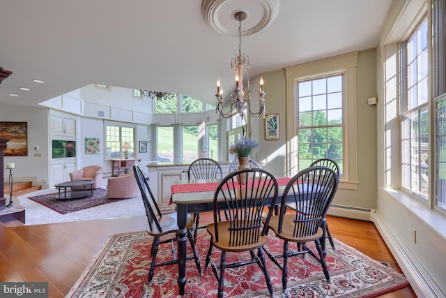 5751 Mount Pisgah Rd, York, PA 17406 - dining room featuring plenty of natural light, light wood-style flooring, a chandelier, recessed lighting, and a baseboard heating unit