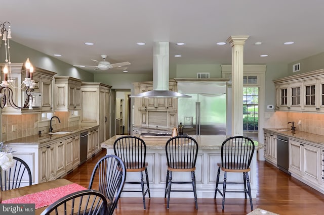 5751 Mount Pisgah Rd, York, PA 17406 - kitchen with cream cabinets, stainless steel appliances, wall chimney exhaust hood, light stone counters, and recessed lighting