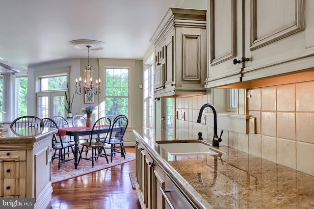 5751 Mount Pisgah Rd, York, PA 17406 - kitchen with dark wood finished floors, tasteful backsplash, decorative light fixtures, a chandelier, and light stone counters
