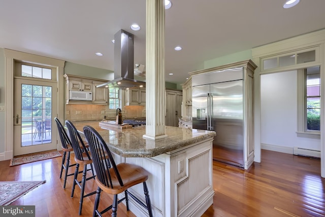 5751 Mount Pisgah Rd, York, PA 17406 - kitchen featuring stainless steel built in fridge, white microwave, island range hood, baseboard heating, and a kitchen island