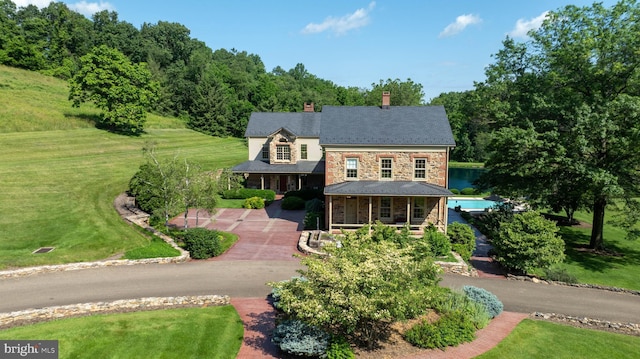 5751 Mount Pisgah Rd, York, PA 17406 - traditional home with a porch, a chimney, a front yard, and stone siding