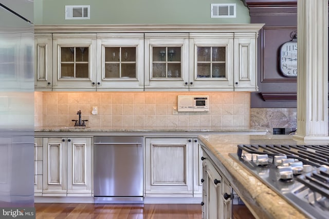 5751 Mount Pisgah Rd, York, PA 17406 - kitchen featuring appliances with stainless steel finishes, cream cabinets, glass insert cabinets, tasteful backsplash, and light stone counters