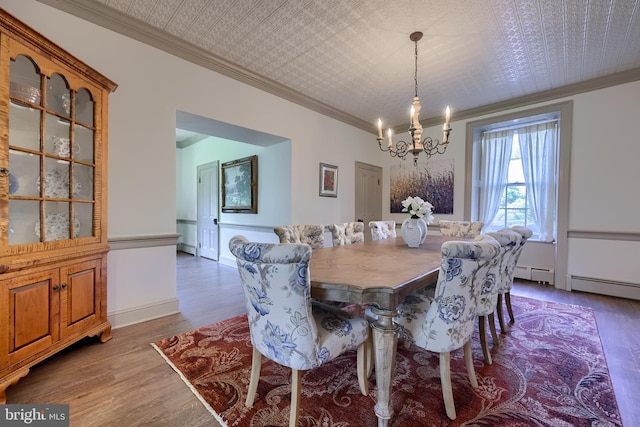 5751 Mount Pisgah Rd, York, PA 17406 - dining space featuring a chandelier, crown molding, wood finished floors, a baseboard radiator, and an ornate ceiling