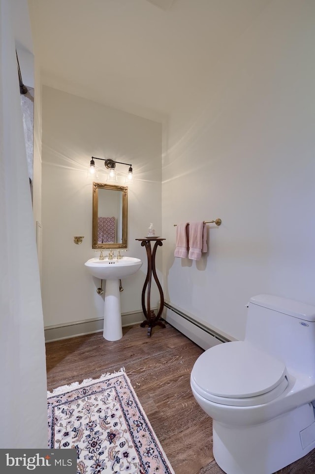 5751 Mount Pisgah Rd, York, PA 17406 - bathroom featuring a baseboard heating unit and wood finished floors