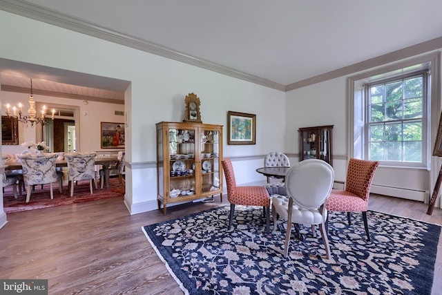 5751 Mount Pisgah Rd, York, PA 17406 - dining room with a chandelier, a baseboard heating unit, wood finished floors, crown molding, and baseboard heating