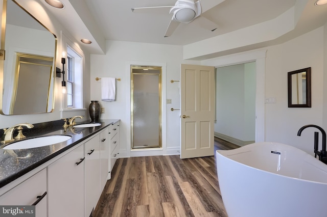 5751 Mount Pisgah Rd, York, PA 17406 - bathroom with a stall shower, double vanity, a freestanding tub, a ceiling fan, and wood finished floors