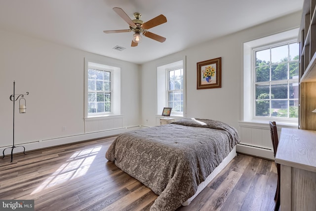 5751 Mount Pisgah Rd, York, PA 17406 - bedroom featuring baseboard heating, multiple windows, and wood finished floors