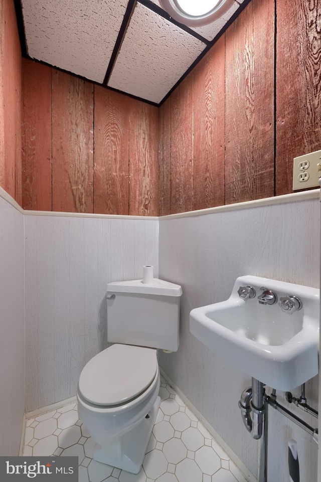 5751 Mount Pisgah Rd, York, PA 17406 - bathroom with wood walls, tile patterned floors, and wainscoting