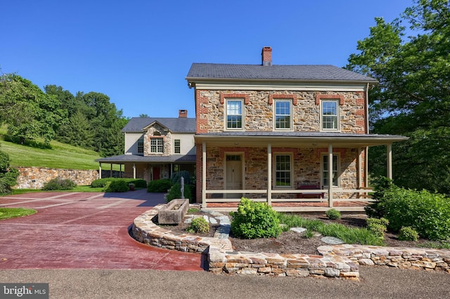 5751 Mount Pisgah Rd, York, PA 17406 - view of front of house featuring stone siding, a porch, and a chimney
