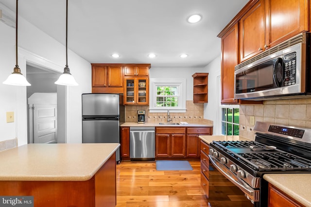 206 E Lake Ave, Baltimore, MD 21212 - kitchen featuring stainless steel appliances, brown cabinets, light wood-style floors, light countertops, and recessed lighting