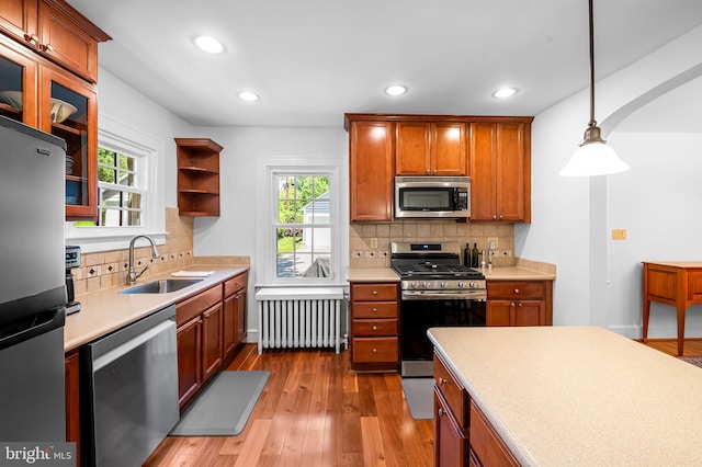 206 E Lake Ave, Baltimore, MD 21212 - kitchen featuring appliances with stainless steel finishes, radiator, wood finished floors, light countertops, and recessed lighting