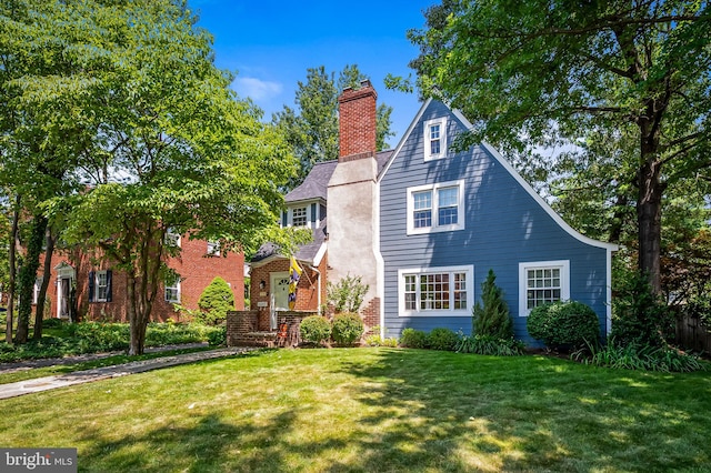 206 E Lake Ave, Baltimore, MD 21212 - view of front of home featuring a front yard, a chimney, and brick siding