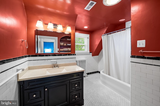 206 E Lake Ave, Baltimore, MD 21212 - full bathroom with tile walls, radiator, vanity, wainscoting, and tile patterned floors