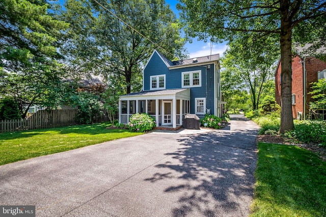 206 E Lake Ave, Baltimore, MD 21212 - view of front facade featuring a sunroom and driveway