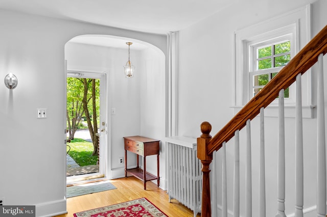 206 E Lake Ave, Baltimore, MD 21212 - foyer with arched walkways, healthy amount of natural light, light wood-style flooring, and stairs