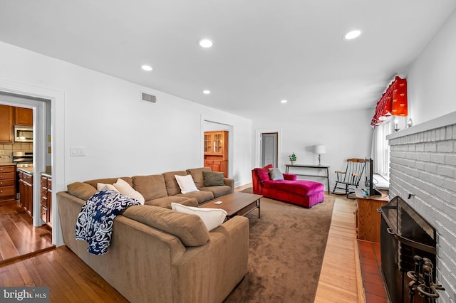206 E Lake Ave, Baltimore, MD 21212 - living area with wood-type flooring, a fireplace, and recessed lighting