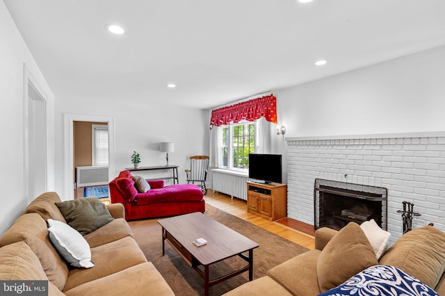 206 E Lake Ave, Baltimore, MD 21212 - living area with radiator heating unit, light wood finished floors, recessed lighting, and a fireplace