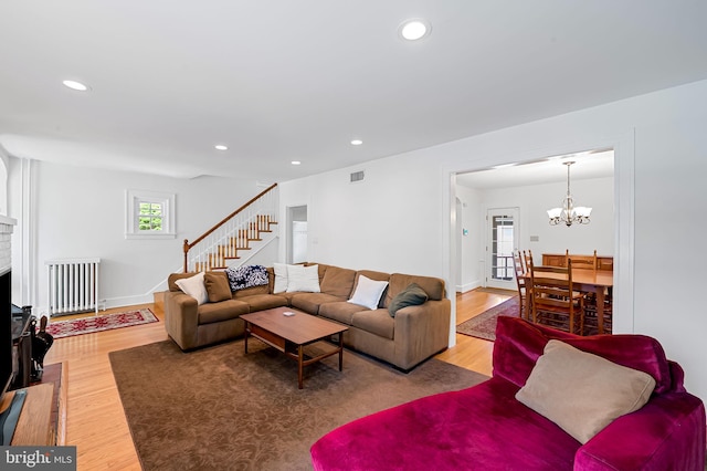 206 E Lake Ave, Baltimore, MD 21212 - living room featuring radiator heating unit, wood finished floors, stairs, recessed lighting, and a chandelier