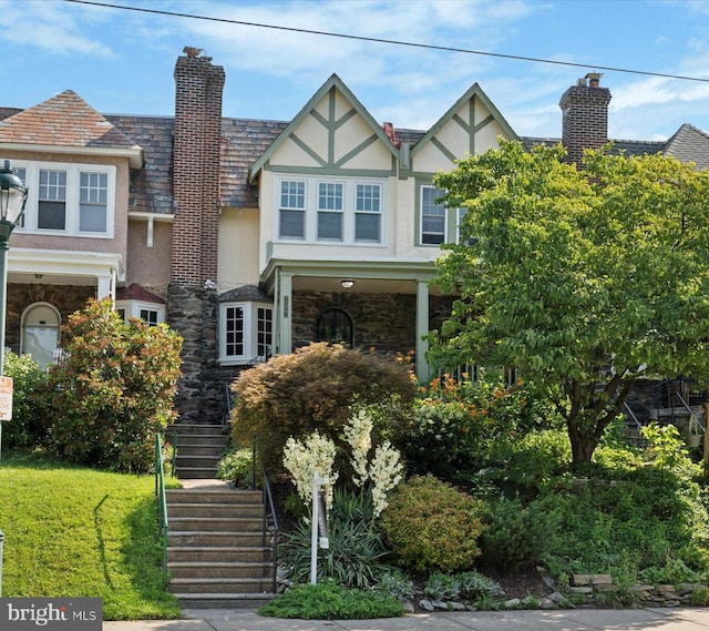 7527 Germantown Ave, Philadelphia, PA 19119 - view of front of house with stucco siding, stairway, stone siding, and a chimney