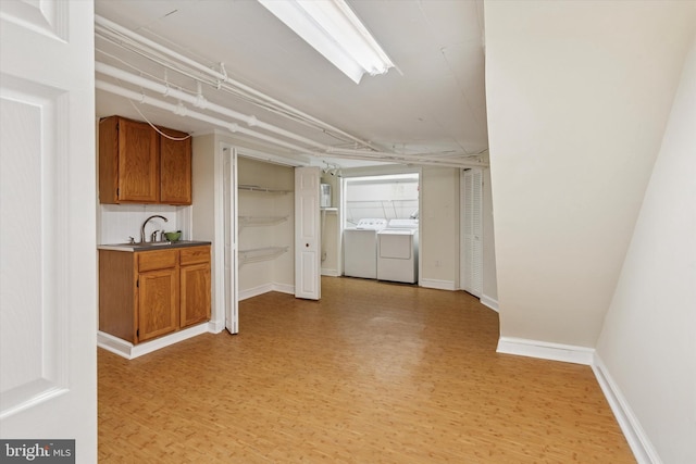 7527 Germantown Ave, Philadelphia, PA 19119 - kitchen featuring washer and dryer, light wood finished floors, and brown cabinetry