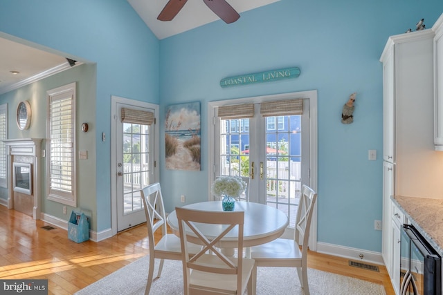 156 E Buckingham Dr, Rehoboth Beach, DE 19971 - dining area featuring a ceiling fan, beverage cooler, light wood-style floors, french doors, and vaulted ceiling