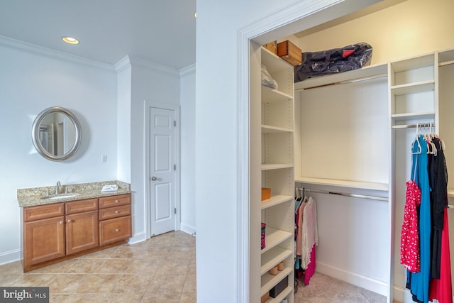 156 E Buckingham Dr, Rehoboth Beach, DE 19971 - bathroom featuring vanity, crown molding, a spacious closet, tile patterned floors, and recessed lighting