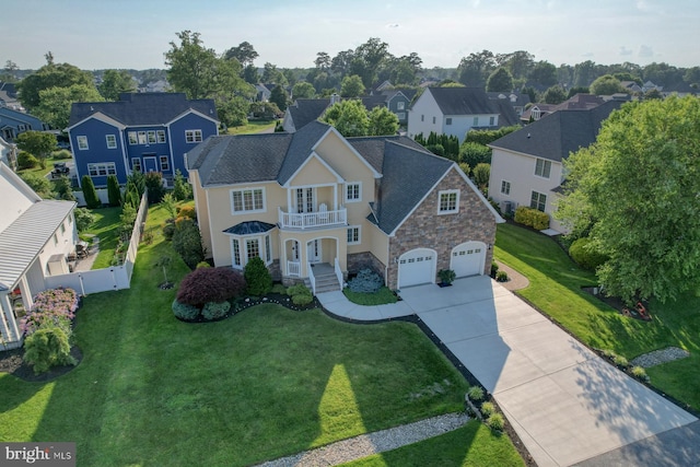 156 E Buckingham Dr, Rehoboth Beach, DE 19971 - traditional home with a balcony, stone siding, a residential view, concrete driveway, and french doors