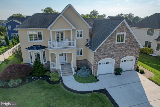156 E Buckingham Dr, Rehoboth Beach, DE 19971 - view of front facade with a balcony, stone siding, covered porch, stucco siding, and driveway