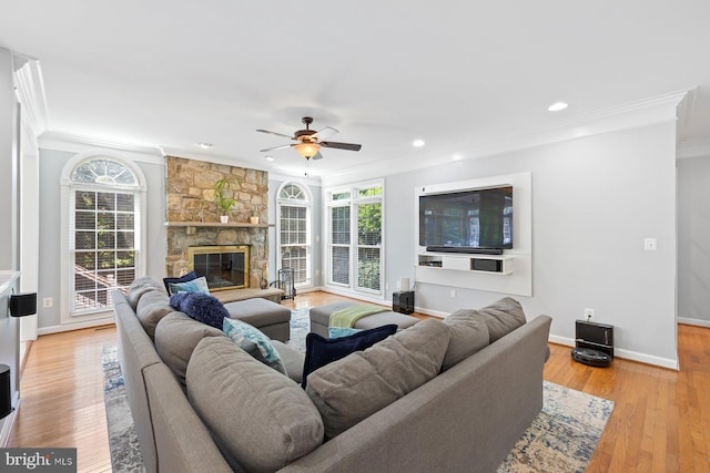 20736 Ashburn Station Pl, Ashburn, VA 20147 - living room with crown molding, a ceiling fan, a fireplace, light wood-style floors, and recessed lighting
