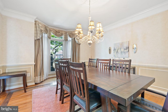 20736 Ashburn Station Pl, Ashburn, VA 20147 - dining area featuring a chandelier, crown molding, light wood-style flooring, and wainscoting