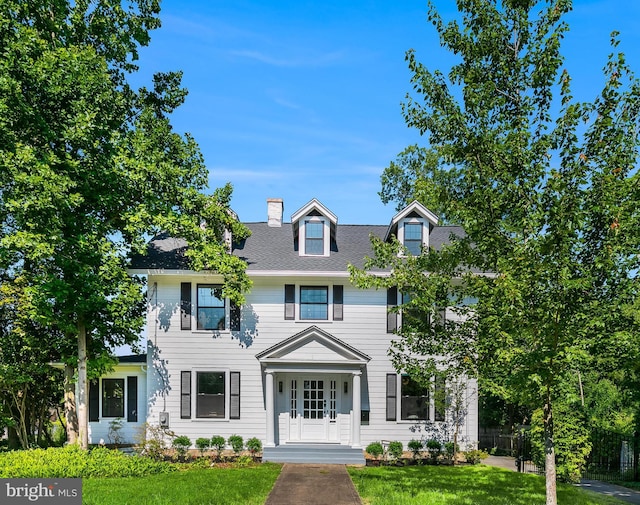 6818 Connecticut Ave, Chevy Chase, MD 20815 - view of front facade featuring a chimney and roof with shingles