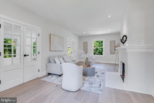 6818 Connecticut Ave, Chevy Chase, MD 20815 - living area featuring wood finished floors, a brick fireplace, and recessed lighting
