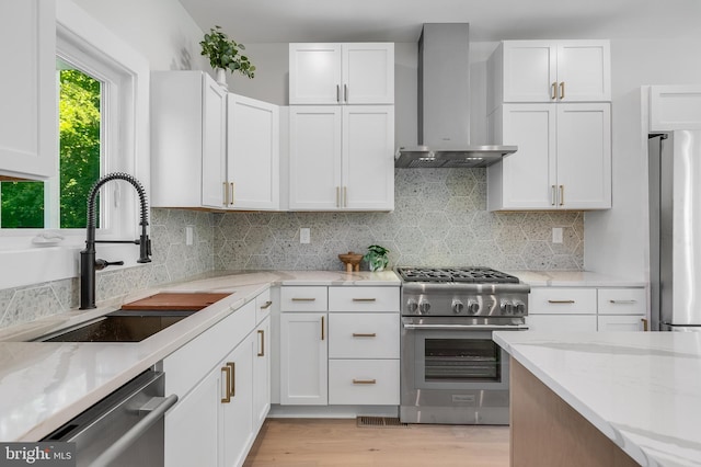 6818 Connecticut Ave, Chevy Chase, MD 20815 - kitchen with wall chimney exhaust hood, stainless steel appliances, light stone counters, white cabinetry, and decorative backsplash