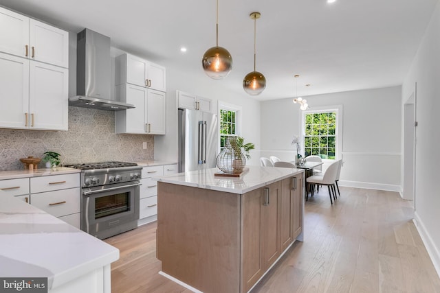 6818 Connecticut Ave, Chevy Chase, MD 20815 - kitchen with wall chimney range hood, high end appliances, backsplash, light wood-type flooring, and light stone countertops