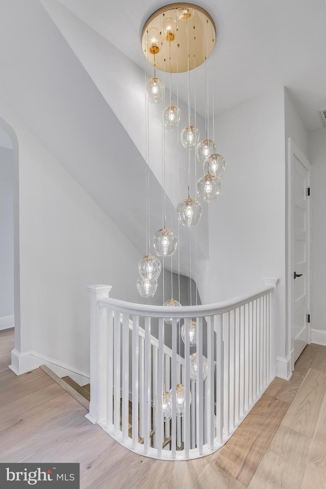6818 Connecticut Ave, Chevy Chase, MD 20815 - stairway featuring wood finished floors and arched walkways