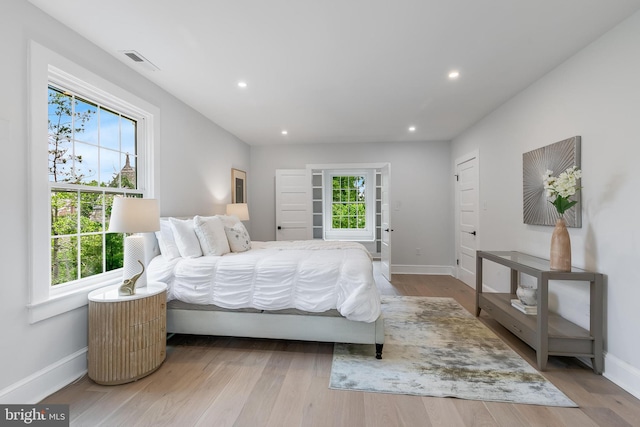6818 Connecticut Ave, Chevy Chase, MD 20815 - bedroom with multiple windows, wood finished floors, and recessed lighting
