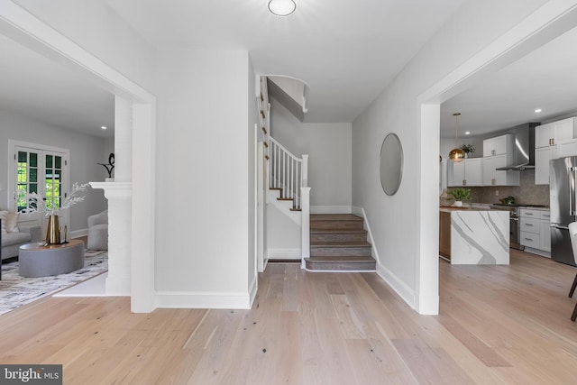 6818 Connecticut Ave, Chevy Chase, MD 20815 - entrance foyer with stairs and light wood-style floors