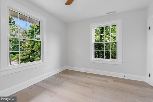 6818 Connecticut Ave, Chevy Chase, MD 20815 - empty room with healthy amount of natural light, light wood-style flooring, and a ceiling fan