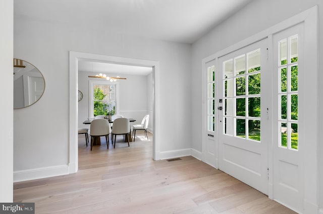 6818 Connecticut Ave, Chevy Chase, MD 20815 - entrance foyer featuring a chandelier and light wood-type flooring