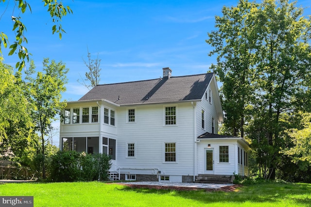 6818 Connecticut Ave, Chevy Chase, MD 20815 - rear view of house with a lawn, a chimney, a shingled roof, and a patio area