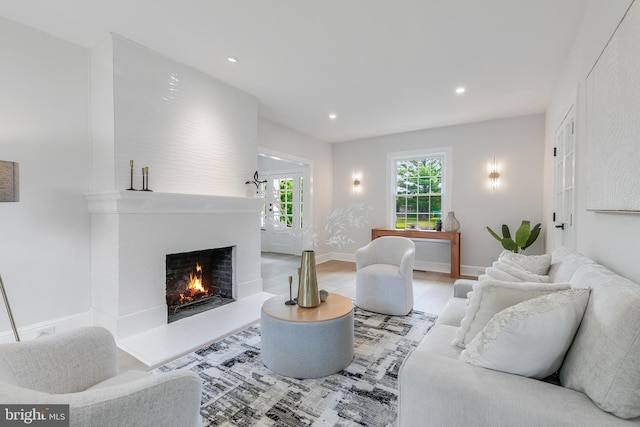 6818 Connecticut Ave, Chevy Chase, MD 20815 - living room with a warm lit fireplace, wood finished floors, and recessed lighting