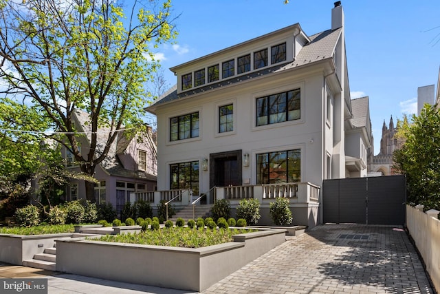3119 38th St NW, Washington, DC 20016 - view of front of home featuring stucco siding and a chimney