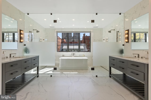 3119 38th St NW, Washington, DC 20016 - full bathroom with a freestanding tub, two vanities, healthy amount of natural light, and recessed lighting