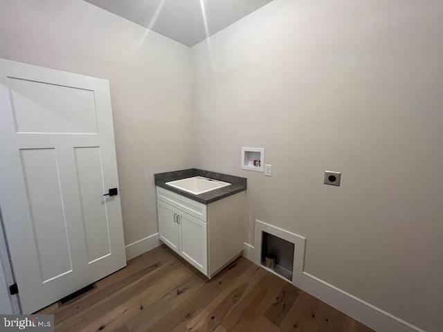 937 Swinehart Rd Unit C, Boyertown, PA 19512 - washroom with electric dryer hookup, washer hookup, light wood finished floors, and cabinet space